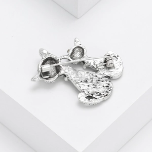 Retro couple cat brooch in antique silver finish showing pin clasp on white geometry stand