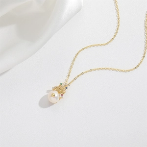Elegant gold necklace featuring a crown pearl pendant with colorful gemstones on white silk