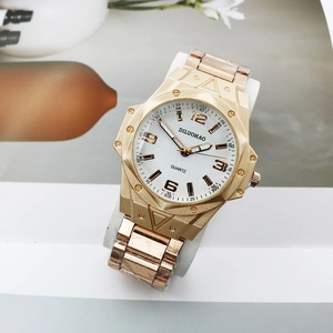 Detail of gold quartz watch with octagonal brushed case and three-row metal link bracelet