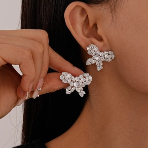 Elegant zircon butterfly stud earrings in silver plating shown on a female model's ear