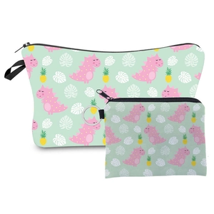 Detail of travel makeup bag set with cartoon dinosaur and pineapple prints on green fabric