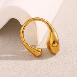 Detail of 18K gold plated snake head ring with pearl accent on a minimalist stone base