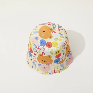 Close-up of baby bucket hat featuring colorful smiling faces and bear patterns
