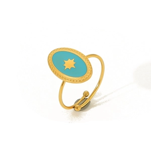 Detail of bohemian gold stainless steel ring with blue enamel and star engraving