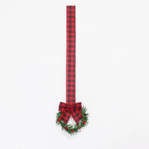 Christmas cabinet wreath with red berry accents and red black plaid ribbon bow decoration