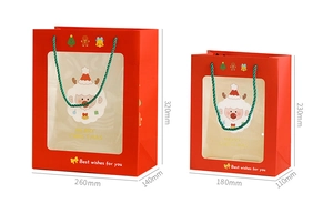 Detail of Christmas gift bags with transparent windows and green woven handles