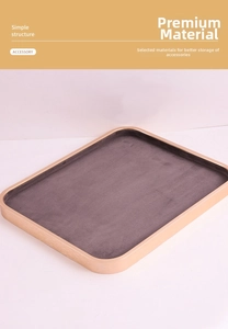 Close-up of rose gold metal jewelry tray with grey velvet lining for accessory display