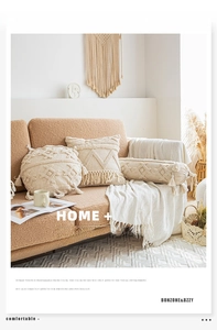 Detail of bohemian cream pillow set with hand-woven textures and fringe on sofa