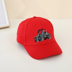 Detailed close-up of red kids baseball cap featuring embroidered monster truck design