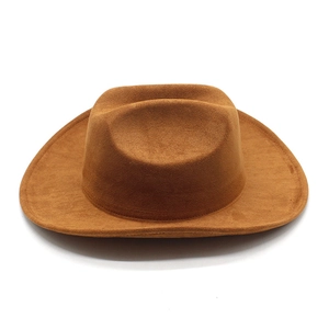 Close-up of brown suede western cowboy hat with wide brim and classic indented crown detail