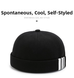 Detailed macro view of black Miki Hat featuring three white stripes on cotton fabric