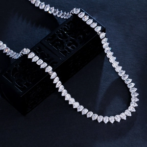 Macro shot of silver bridal necklace featuring pear-cut cubic zirconia in U-shape display