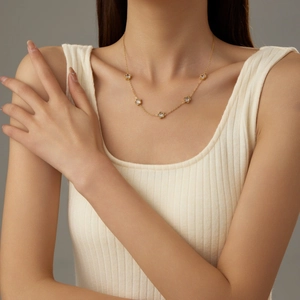 Elegant gold five-leaf flower zircon necklace shown on model with minimalist design