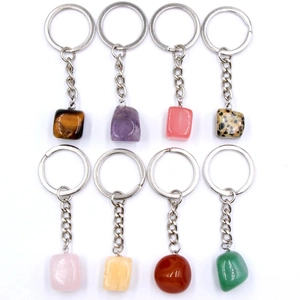 Detailed collection of eight natural crystal and agate stone keychains on white background