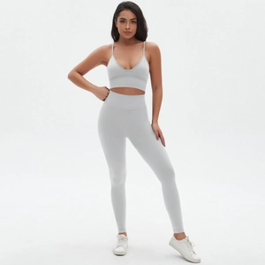 Detail of light grey seamless yoga set showing high waist leggings and V-neck sports bra