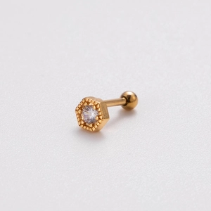 Detailed view of golden hexagonal stud earring with clear zircon and screw ball back