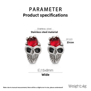 Detail of skull earring in stainless steel with a red zircon inlay and black eye details