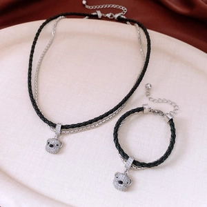 Close-up of double-layer bear necklace and bracelet set with rhinestones and black cord