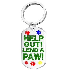 Close-up of stainless steel pet tag with colorful paw prints and Lend a Paw slogan