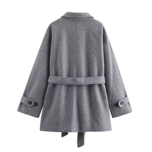 Rear view of grey wool coat showing mid-seam detail and decorative cuff straps with belt