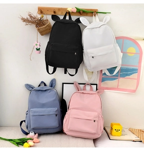 Minimalist school backpacks with rabbit ear details in black, white, blue, and pink colors