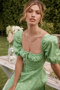 Detail of floral puff sleeve dress with a square neckline and drawstring bust design