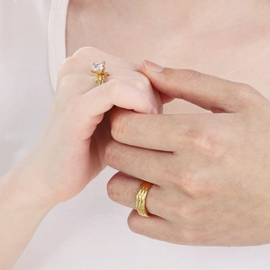 Macro detail of 18K gold plated stainless steel couple rings with 6mm rhombic zircon