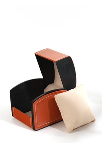 Detail of orange lychee grain PU leather watch box with cream velvet interior and pillow
