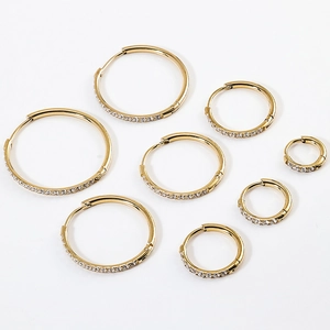 Detailed view of various sized gold stainless steel hoop earrings with cubic zirconia