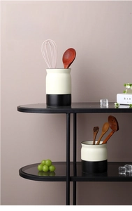 Modern ceramic kitchen utensil holder with drainage holes and minimalist black base stand