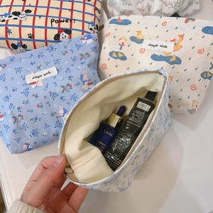 Detailed macro view showing the spacious interior of the blue cotton makeup bag with zipper