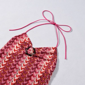 Close-up of colorful striped crochet dress with halter neck tie and decorative ring