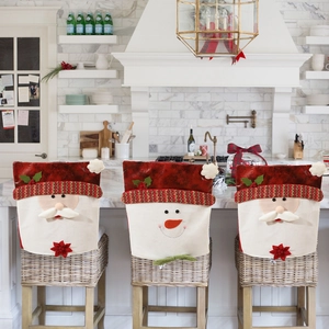 Christmas Santa and Snowman chair covers on bar stools in a festive kitchen scene