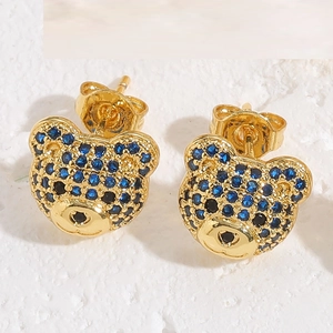Detail shot of cute gold bear earrings featuring blue and black micro-set cubic zirconia