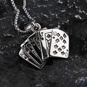 Polished stainless steel ace of spades playing cards pendant necklace on volcanic rock
