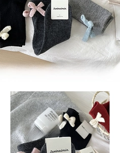 Detailed texture of wool knit socks featuring elegant bow accents and cozy ribbed design