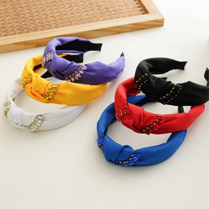Close-up of six colorful knotted headbands with matching rhinestones in a neat row
