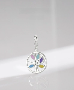 Macro detail of S925 sterling silver tree pendant with colorful enamel leaf accents