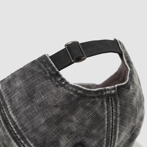 Rear view of washed dark grey kids baseball cap featuring an adjustable metal buckle strap
