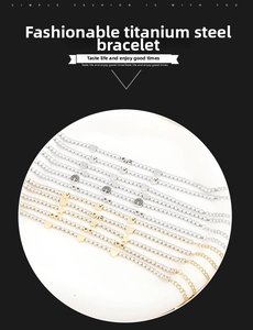 Detail of silver and gold tennis bracelets with heart and infinity pendants in titanium steel