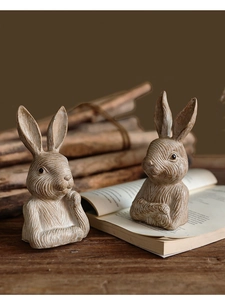 Detailed close-up of retro resin rabbit figurines with vintage wood-carved texture