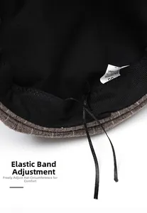 Detailed view of internal adjustable drawstring for custom sizing on checkered newsboy cap