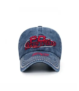 Macro detail of red 3D PC Engrae embroidery on washed dark blue denim baseball cap