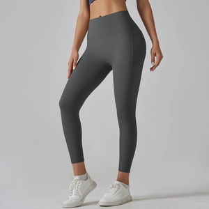 Detailed close-up of dark grey high-waisted yoga leggings with side pockets and flatlock seams