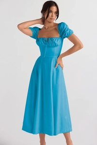 Detail of light blue puff sleeve dress featuring a square neckline and high-quality fabric