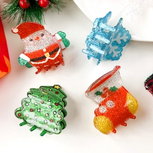 Detail of Christmas hair claw clips set including Santa, snowflake, and tree designs