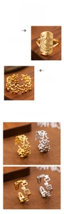 Detail of gold moon and star signet ring with hollow geometric designs and flower patterns