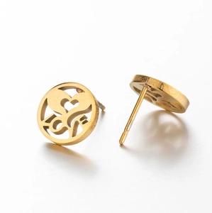 Macro detail of gold-plated stainless steel heart studs with intricate laser-cut patterns