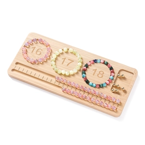 Bamboo bead design board with circular measurement slots and linear scale for DIY jewelry