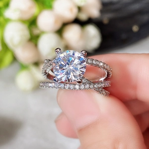 Detailed view of silver cross ring with four-prong round zircon and micro-paved small diamonds
